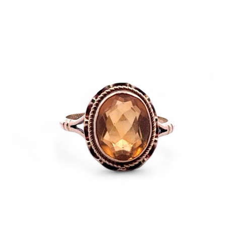 46 - An oval cut citrine ring with 9ct gold rope twist mount, size K. 2.59g.