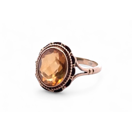 46 - An oval cut citrine ring with 9ct gold rope twist mount, size K. 2.59g.