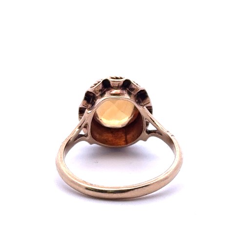 46 - An oval cut citrine ring with 9ct gold rope twist mount, size K. 2.59g.