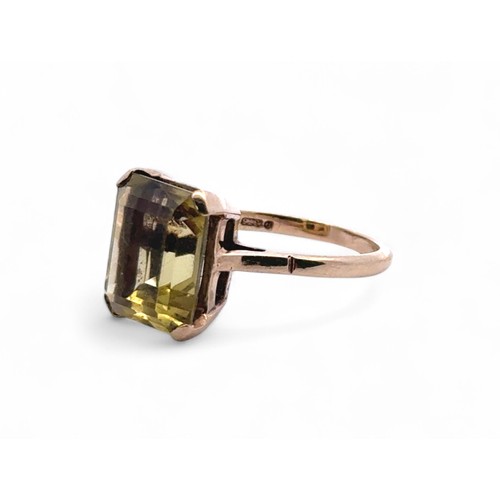 87 - An emerald cut greenish-yellow quartz ring set in 9ct gold, size L. 3.6g.