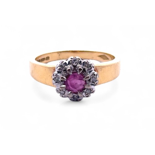 103 - An 18ct gold, ruby and diamond cluster ring. Size N. Weight 4.88g.