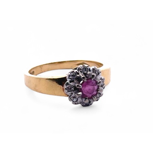 103 - An 18ct gold, ruby and diamond cluster ring. Size N. Weight 4.88g.