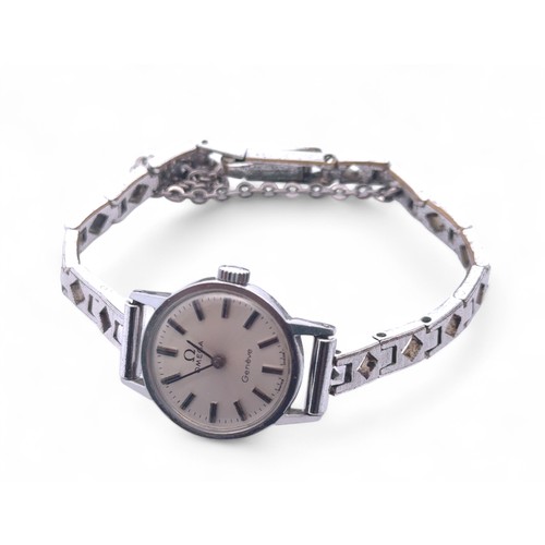 143 - An Omega Geneve ladies stainless steel watch on a white metal unmarked bracelet.