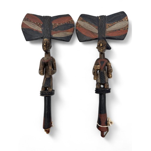 351 - A pair of African Yoruba Shango staffs with carved figural design and large axe-shaped upper, string... 