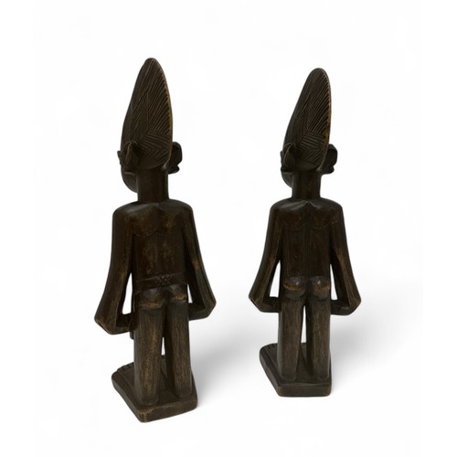 352 - A pair of African Yoruba figures in the form of a male and female, carved wooden standing figures. H... 