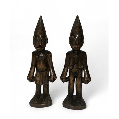 352 - A pair of African Yoruba figures in the form of a male and female, carved wooden standing figures. H... 