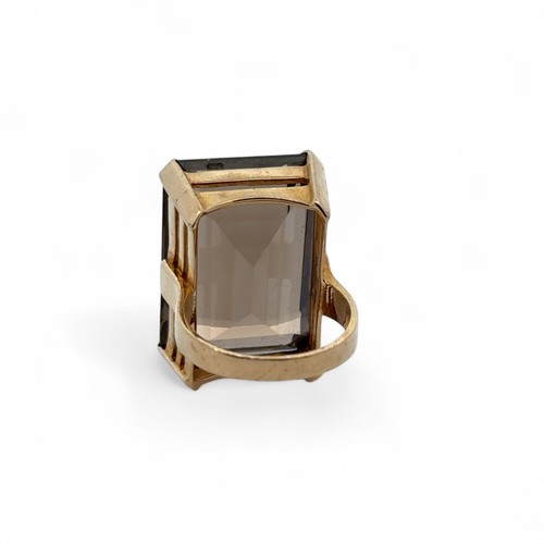 67 - A large smoky quartz 9ct gold ring, size N. Quartz approx 25mm x 18mm. 14.05g