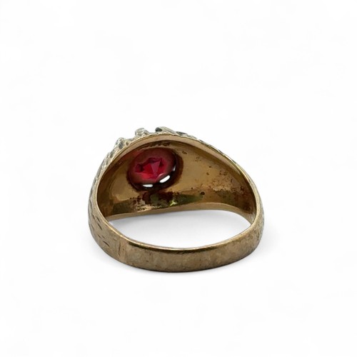 34 - A 9ct gold and garnet ring with sunburst setting and bark effect shank. Size L. 4.5g