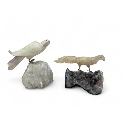 356 - Two carved quartz birds on mineral quartz stands. A parrot with pale amethyst tail feathers and beak... 