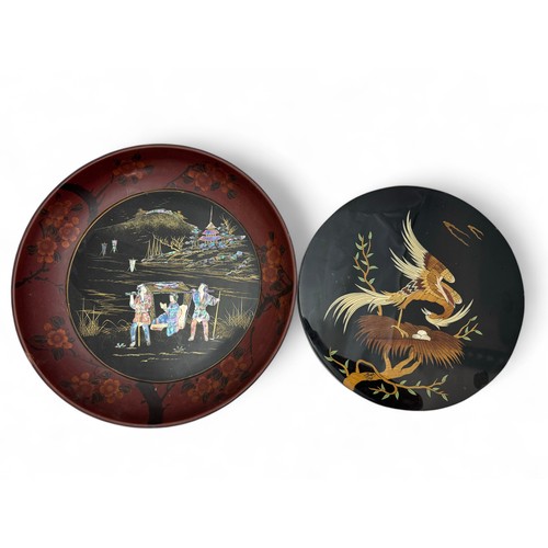 340 - A Shibayama plaque and bowl. A circular black lacquered plaque decorated with a bird tending its' ne... 