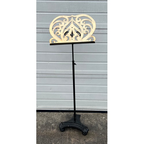 449 - A Victorian cast iron and polished brass music stand. Height 137cm (adjustable).