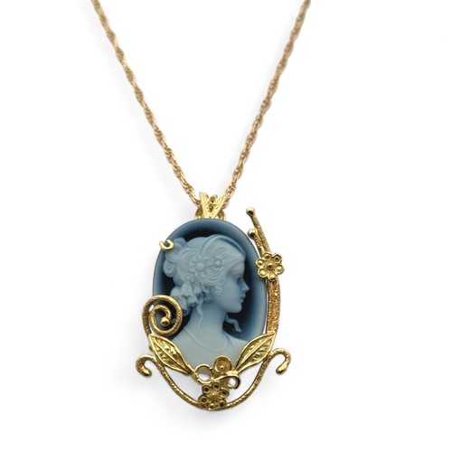 34A - An Italian blue agate cameo pendant set in a fancy gold mount stamped 750, on a 9ct gold chain. Pend... 