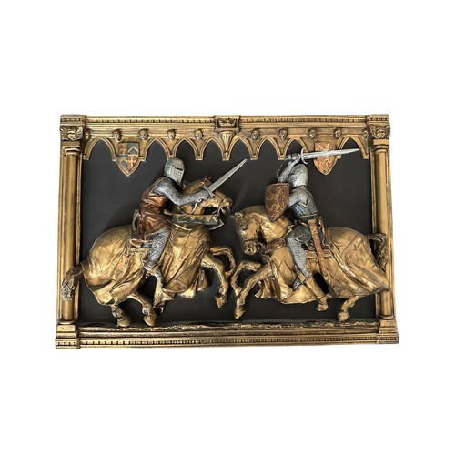 85 - A pair of Marcus Designs hall plaques of jousting/fighting knights, both 22cm by 32cm.