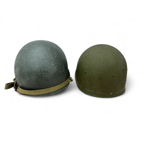 62 - Second World War US M1 helmet and liner, fixed chinstrap bails with fitted chinstrap with blackened ... 