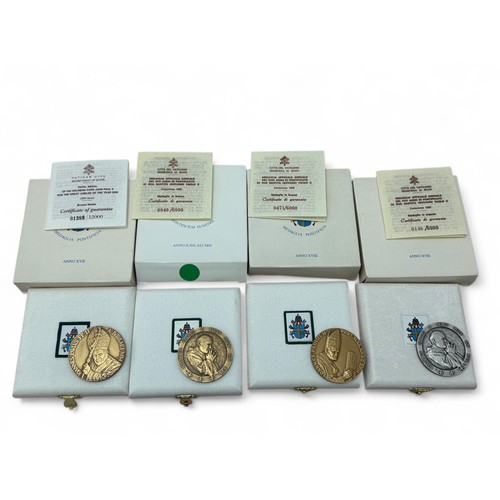 116 - Four Pope John Paul II limited edition commemorative medals. Includes: A bronze anno xvii medal 940/... 