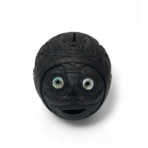 79 - 19th / 20th Century carved coconut bugbear money box. Figural central band, front facing carved face... 