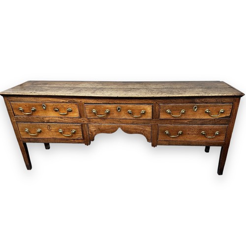 443 - Late 18th / Early 19th Century oak five drawer dresser base. Brass fittings, rectangular top split o... 