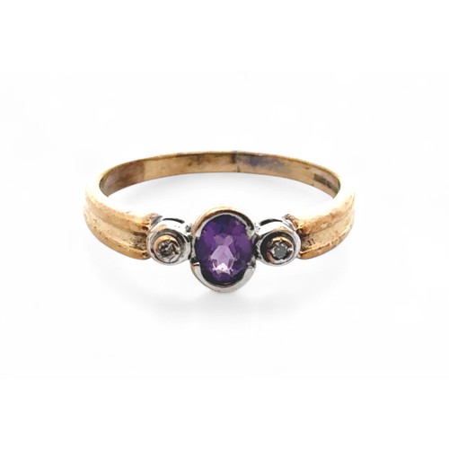 69 - An amethyst ring with diamond accents, set in 9ct gold. Size P. Weight 2.26g.