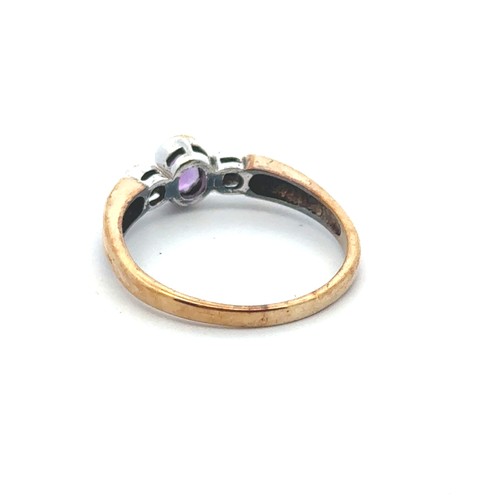 69 - An amethyst ring with diamond accents, set in 9ct gold. Size P. Weight 2.26g.