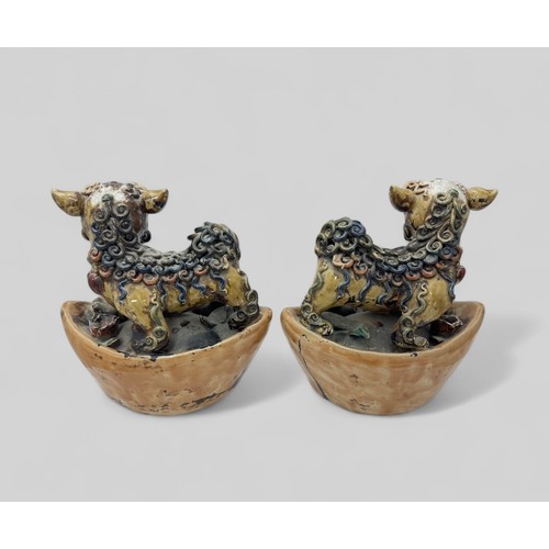 295 - Chinese pottery pair of ferocious Foo Dogs stood on bases. Unsigned, some chips and damage. Height 2... 