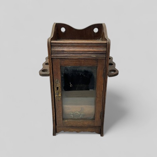 256 - An Oak glass fronted smokers / smoking cabinet with brass fittings. Height 32cm, width 21cm, depth 1... 