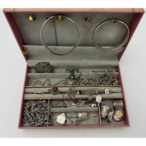 83 - A quantity of silver and costume jewellery. Includes 2 silver bangles, silver rings, bracelets, earr... 