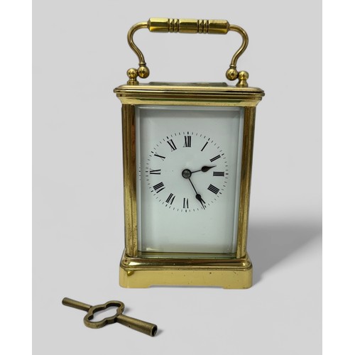 171 - A French 19th Century brass carriage clock having swan neck handles and glazed panels to each sides,... 