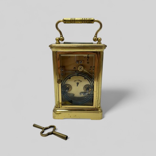 171 - A French 19th Century brass carriage clock having swan neck handles and glazed panels to each sides,... 