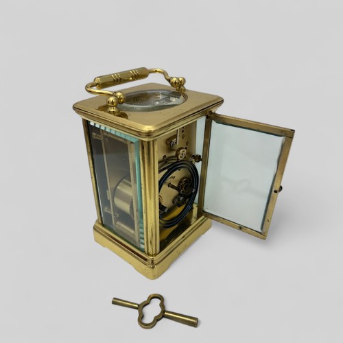 171 - A French 19th Century brass carriage clock having swan neck handles and glazed panels to each sides,... 