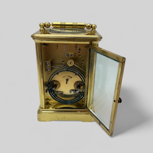 171 - A French 19th Century brass carriage clock having swan neck handles and glazed panels to each sides,... 