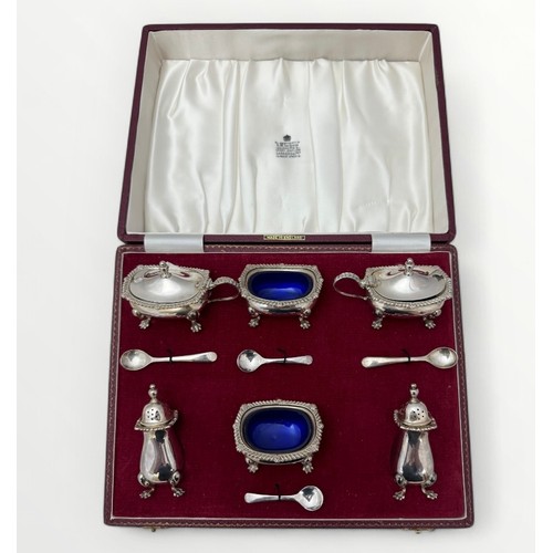 127 - A cased Garrard & Co Ltd six piece silver cruet set with blue glass liners. Birmingham 1968.