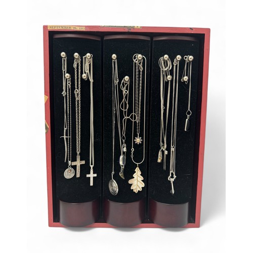 80 - A mirrored jewellery display case containing 13 silver pendant necklaces