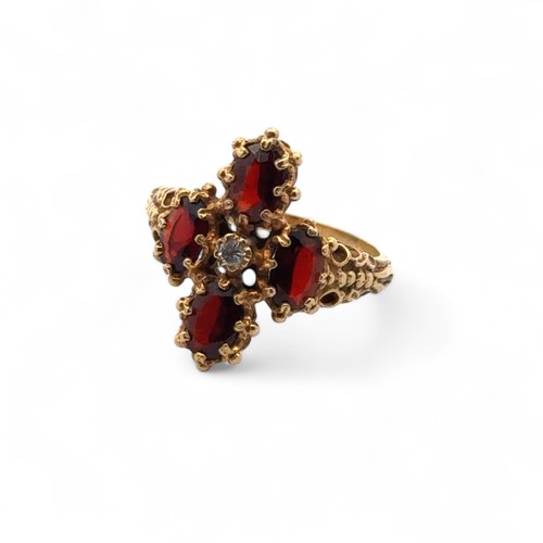 57 - A 18ct gold, garnet and diamond ring, size O/P. Weight 5.68g