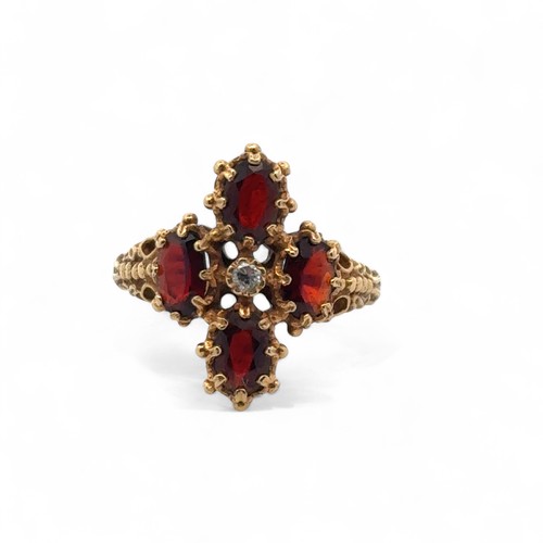 57 - A 18ct gold, garnet and diamond ring, size O/P. Weight 5.68g