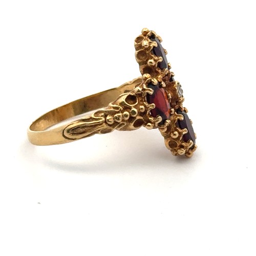 57 - A 18ct gold, garnet and diamond ring, size O/P. Weight 5.68g