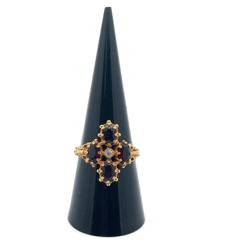 57 - A 18ct gold, garnet and diamond ring, size O/P. Weight 5.68g