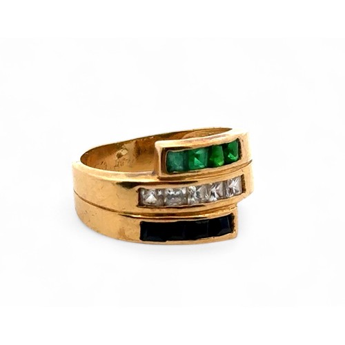 35 - A multi-gem ring with three rows of green white and blue stones in unmarked yellow gold (tests as 18... 