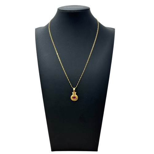 46 - A ruby and yellow gold pendant with a chain stamped 750. necklace.  Pendant is unmarked but tests as... 