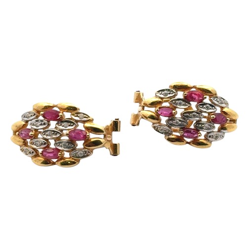 8 - A pair of ruby and diamond earrings in 18ct yellow gold.