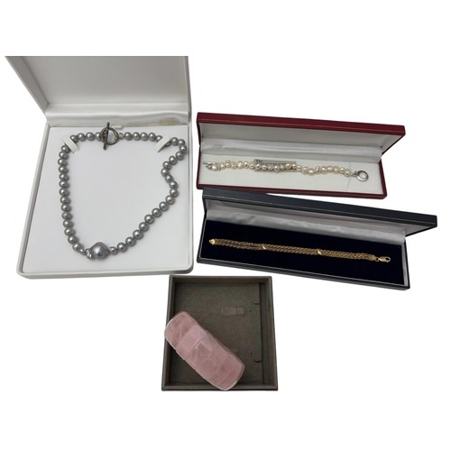 34 - An 18ct gold twin strand bracelet, a rose quartz bracelet and two pearl necklaces.