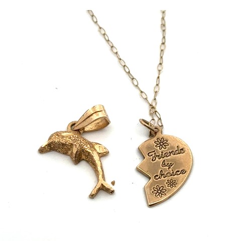 63 - A dolphin pendant 22mm in length, in unmarked but tests as 18ct gold, along with a half heart yellow... 