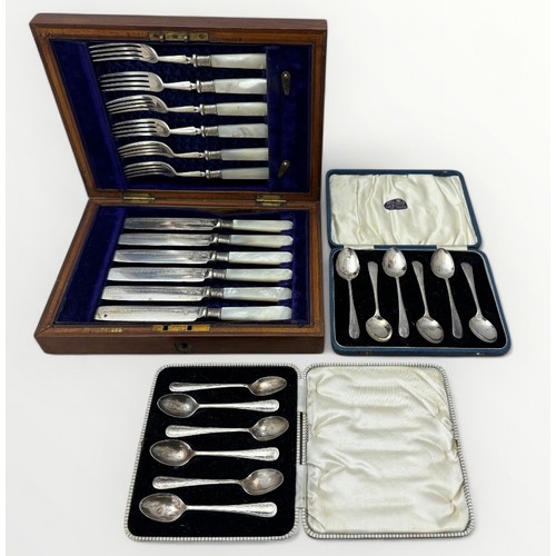 129 - Two cased sets of silver teaspoons and a set of six white metal knives and forks with mother of pear... 