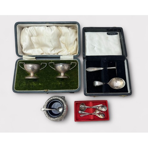 135 - A boxed pair of silver salts with blue glass linings by Matthew John Jessop Birmingham 1908, a cased... 