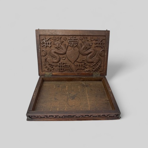 293 - Chinese carved wooden box with dragon design to lid, lid on hinges. Height 5cm, length 31cm, depth 2... 