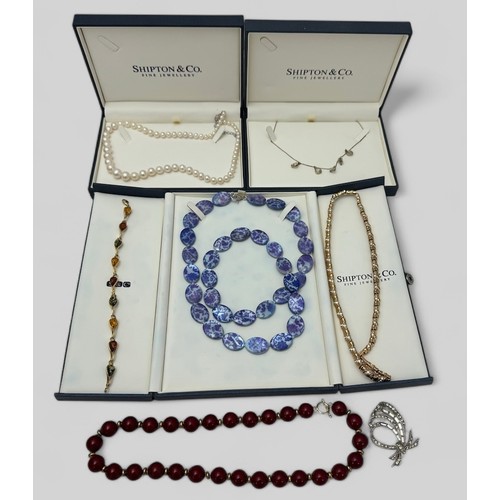 84 - A mixed selection of jewellery including a graduated pearl necklace with silver clasp, a silver and ... 