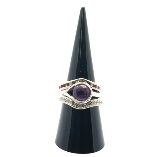 53 - A bespoke set of three rings designed to be worn together. Including an amethyst and diamond cluster... 