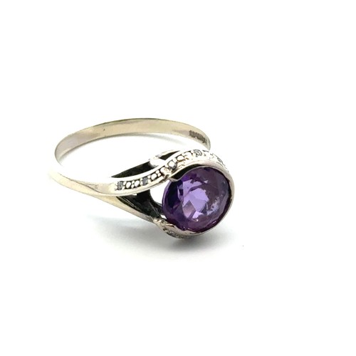 53 - A bespoke set of three rings designed to be worn together. Including an amethyst and diamond cluster... 