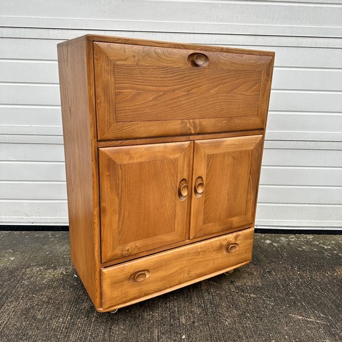 435 - Ercol – an Ercol Windsor model 430 elm serving cabinet or drinks cabinet, with fall-front above doub... 