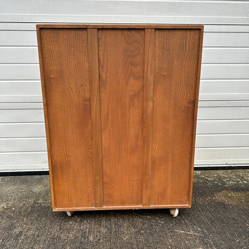 435 - Ercol – an Ercol Windsor model 430 elm serving cabinet or drinks cabinet, with fall-front above doub... 