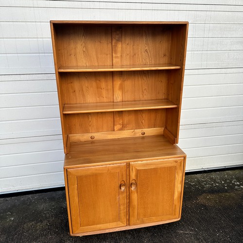 436 - Ercol – an Ercol Windsor blond elm bookcase cabinet with two adjustable shelves, over double cupboar... 